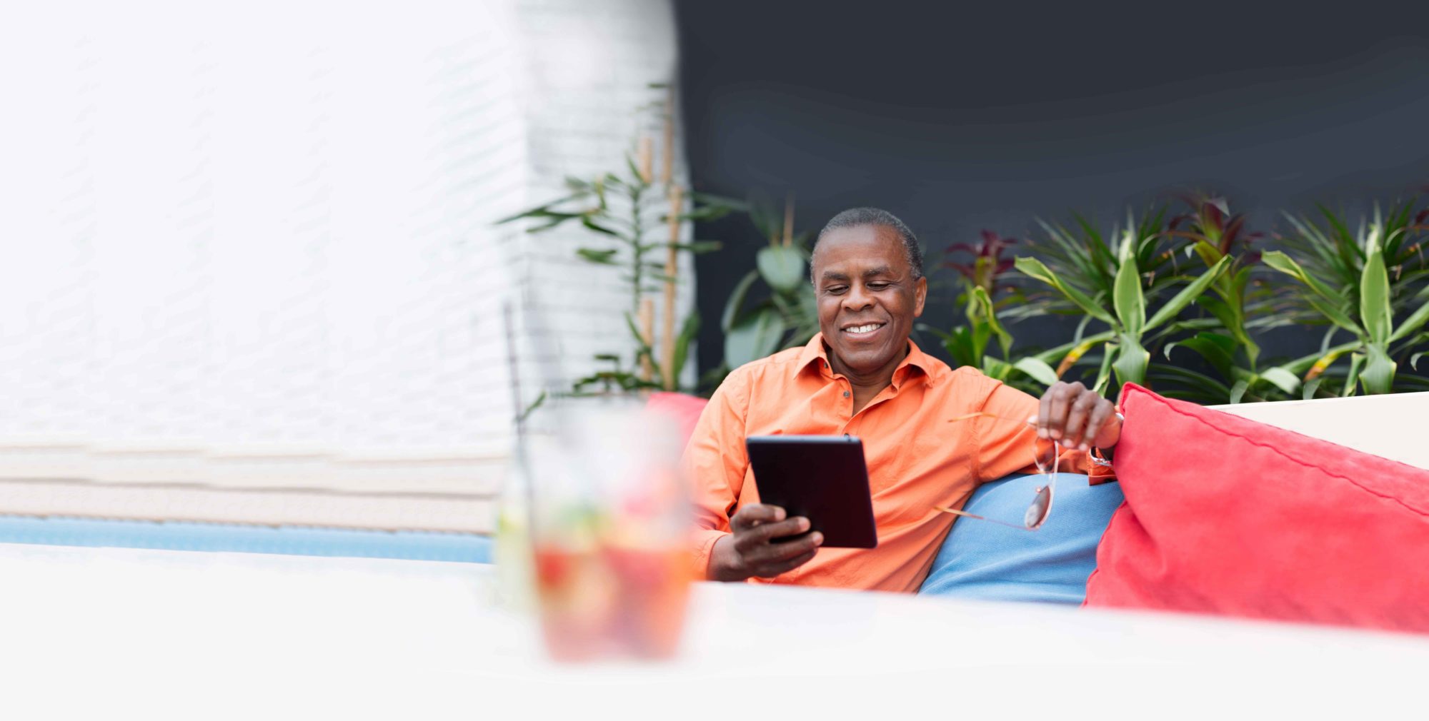 Relaxed man on ipad, generating income with options